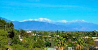 a view of the mountains with trees in the background