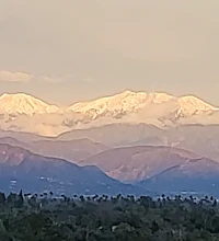 a mountain range with snow capped mountains in the background